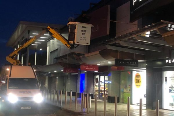 Team Cleaning Exterior Of Shop